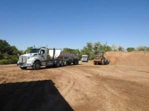 Trucks and Equipment stockpiling dirt